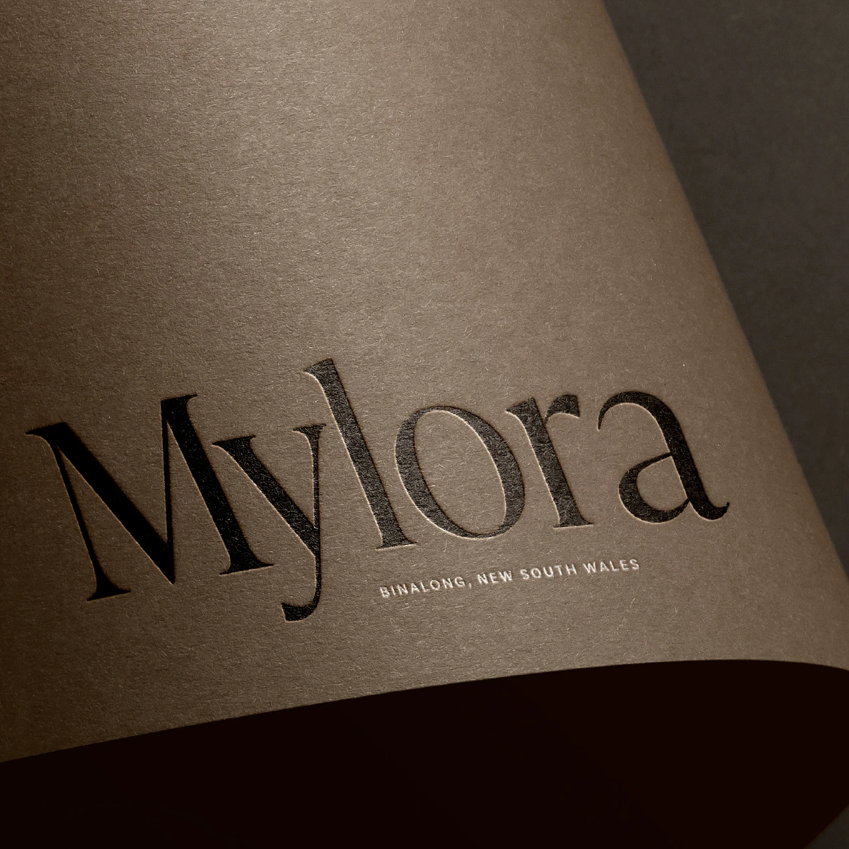 Luxury rural property brand identity for Mylora NSW featuring elegant serif lockup typography on textured paper with sophisticated neutral colour palette